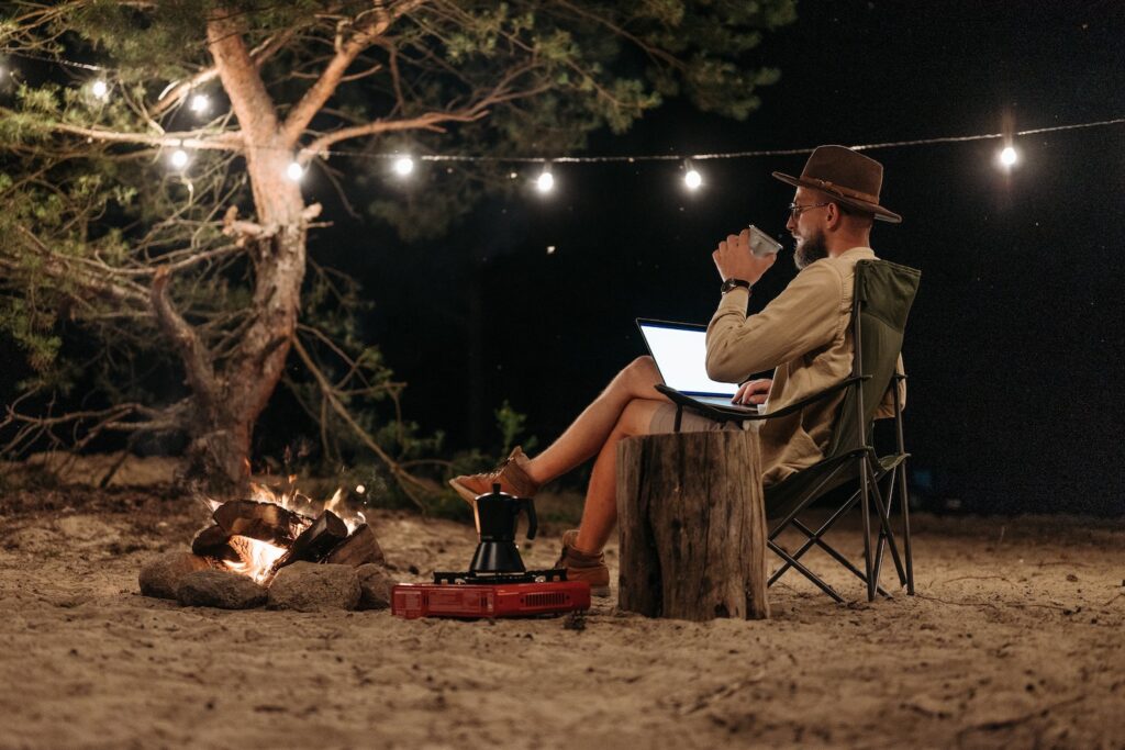 digital nomad working by himself outside at night