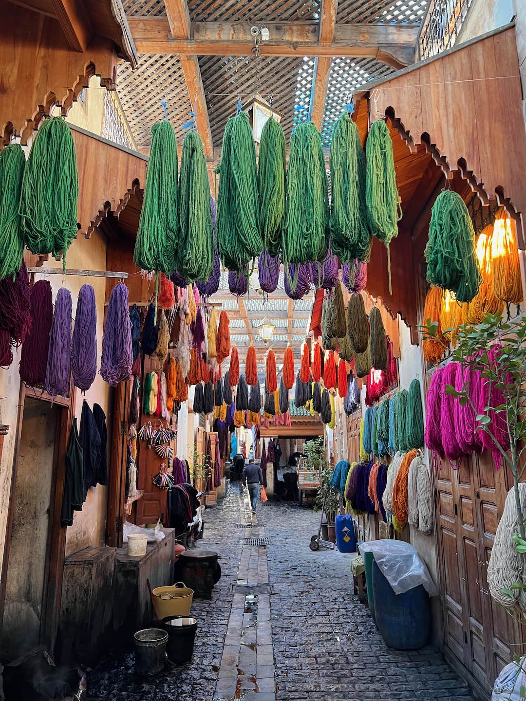 colorful yarn hanging from arches in the medina of fes morocco