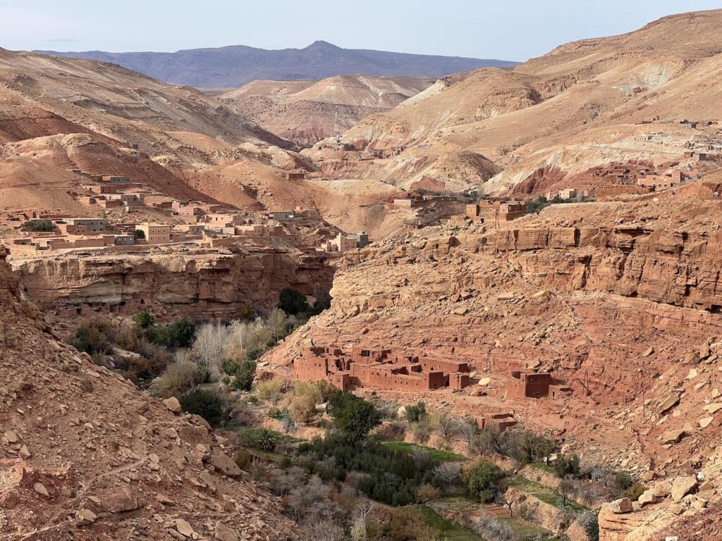 craggy red gorge with villages built into the rocks and an oasis in the valley near telouet morocco