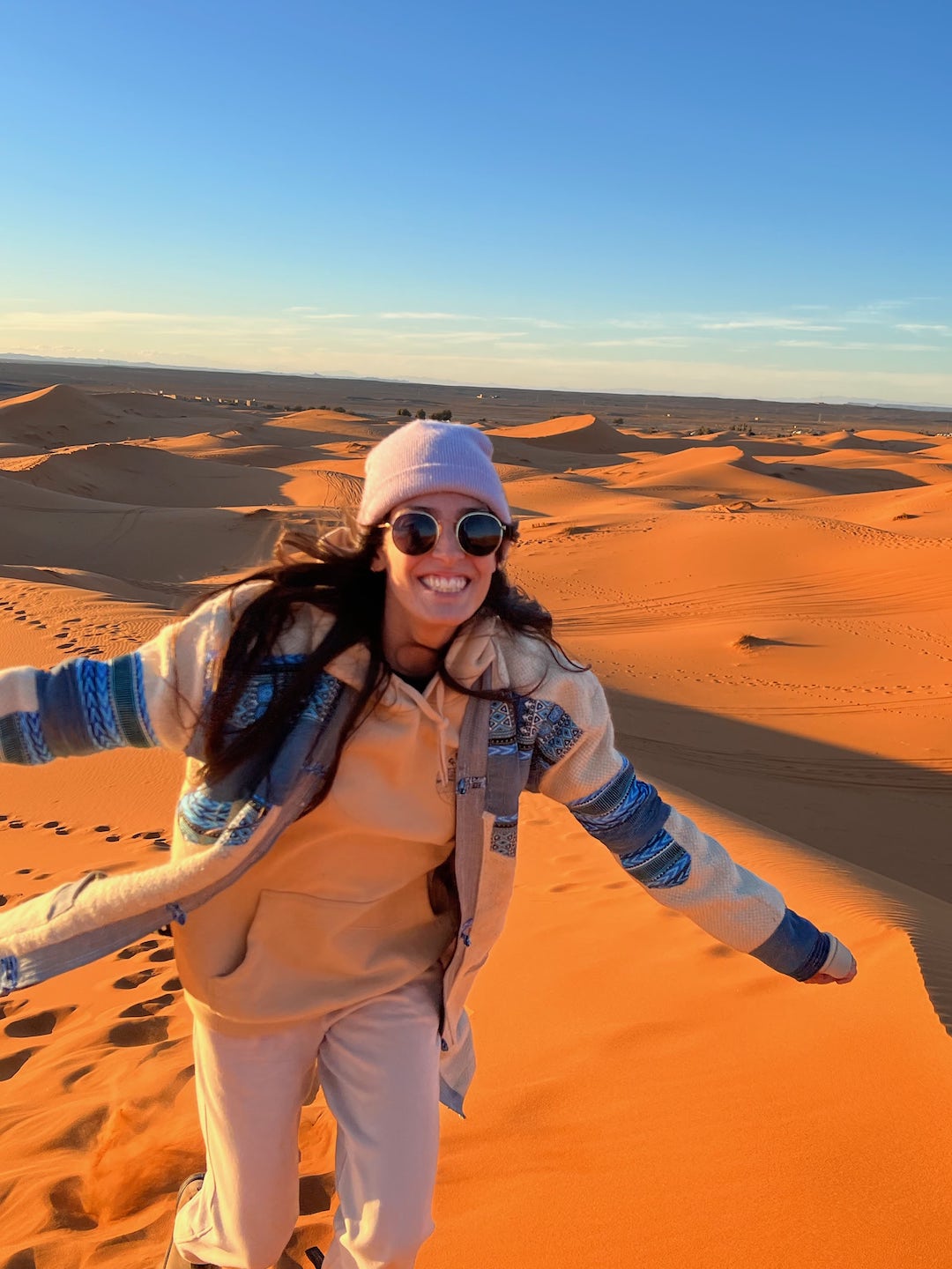 girl wearing a jacket made in essaouira in the desert