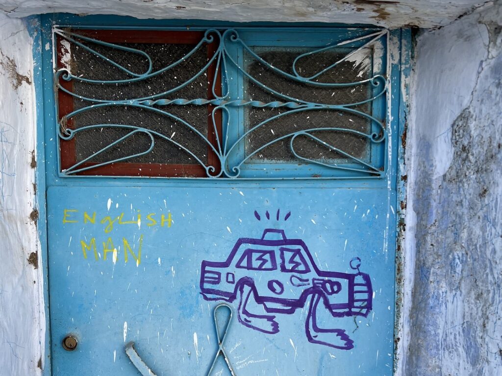one of the best things to do in chefchaouen is hunt for walking taxi street art