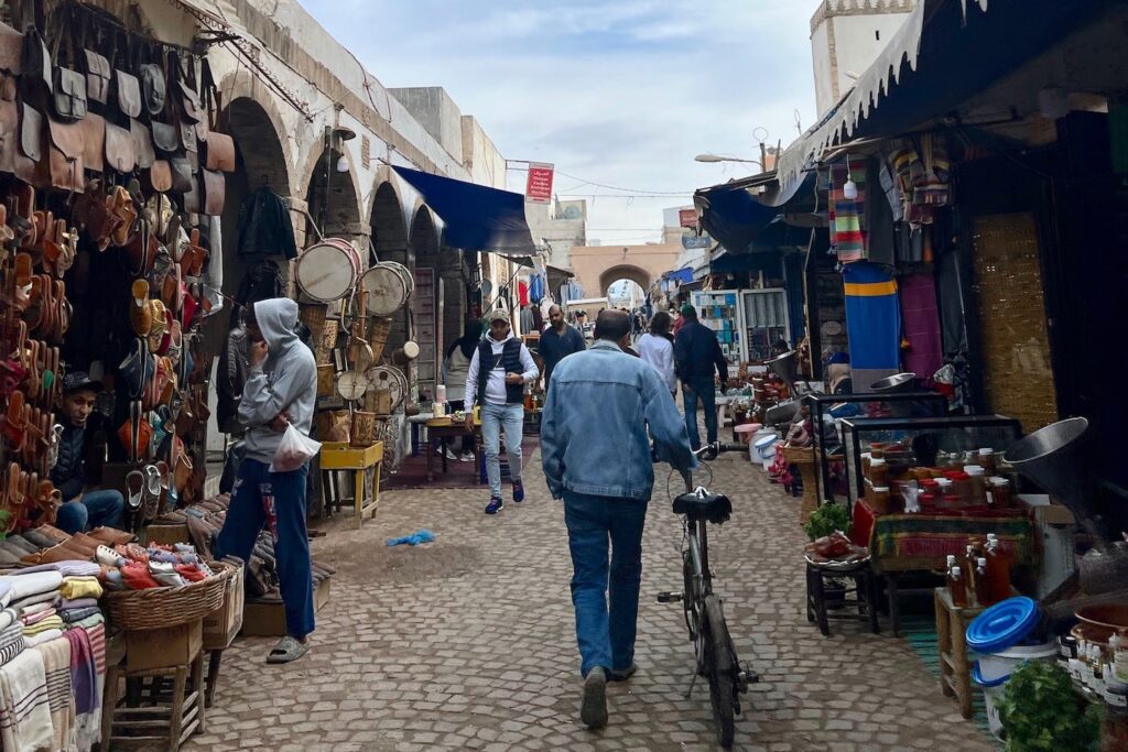 essaouira travel guide man walking in medina with bicycle